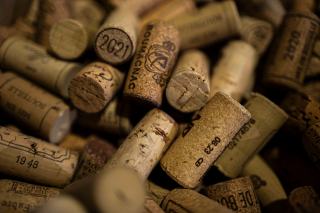 Bouchon de liège posé à côté d'un verre de vin rouge sur une table